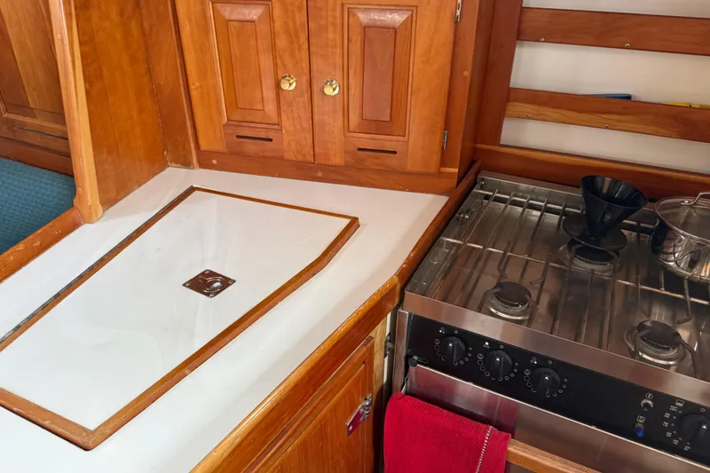 Slide: The Image of Wooden yacht kitchen with stove, sink, and cabinets in Tartan 3700, 2000 model. - 18