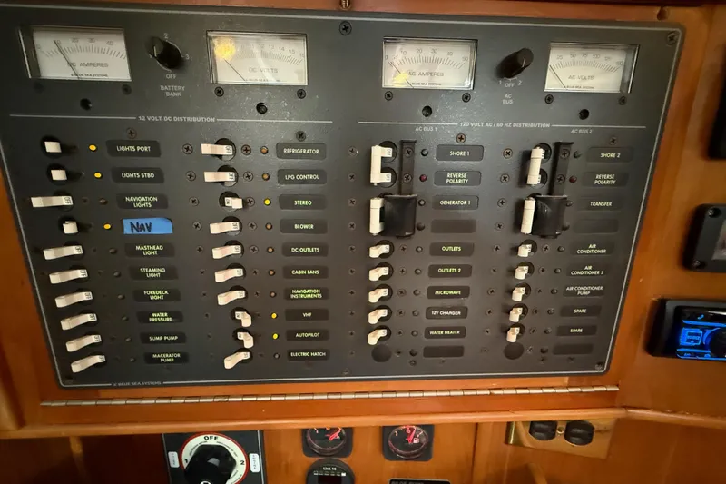 Slide: The Image of Electrical control panel on a 2000 Tartan 3700 yacht, featuring various switches and gauges. - 29
