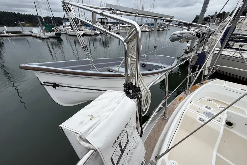 Slide: The Image of Tartan 3700 sailboat from 2000 docked, featuring a lifeboat and marina background. - 42