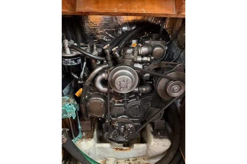 Slide: The Image of Engine of a 2000 Tartan 3700 sailboat, showcasing mechanical components and belts. - 31