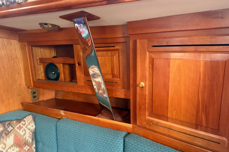 Slide: The Image of Wooden interior of a 2000 Tartan 3700 sailboat with cabinets and seating. - 34