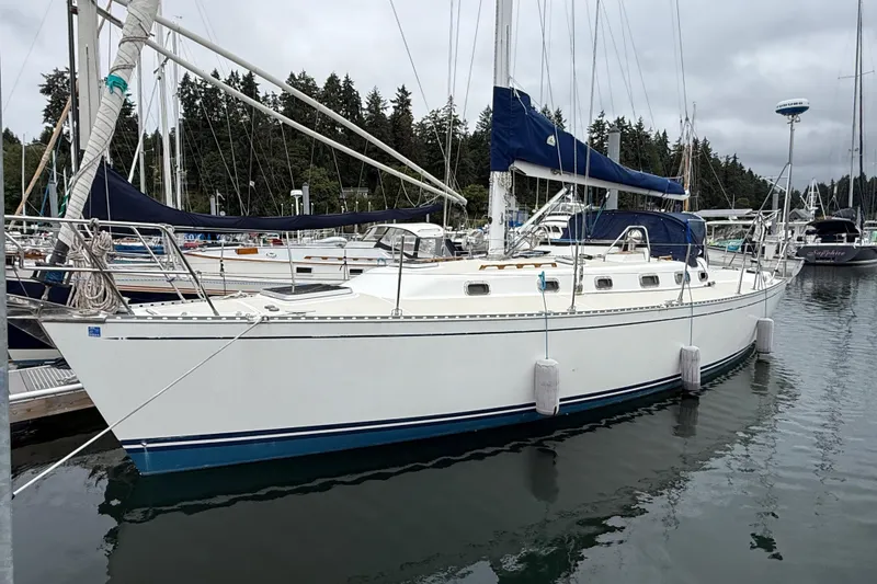 The Image of Sailboat Tartan 3700, 2000 model, docked in a marina with overcast skies. - 0