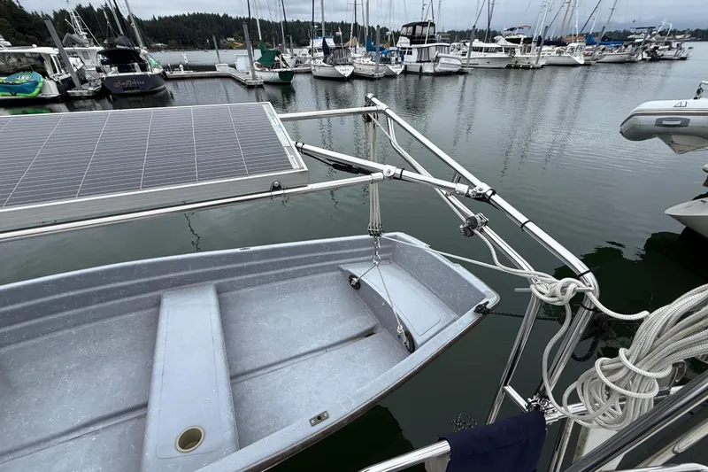 Slide: The Image of Boat docked with solar panel and dinghy, Tartan 3700, 2000 model, marina background. - 46