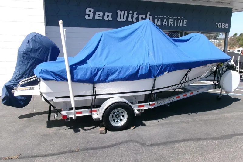 Slide: The Image of 2015 Sea Fox 180 Viper boat covered with blue tarp on trailer at Sea Witch Marine. - 23