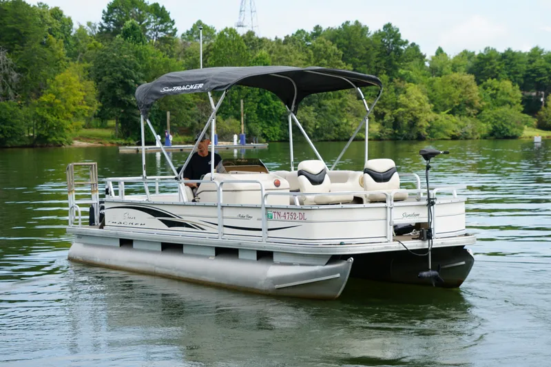 The Image of 2005 Sun Tracker Fishin' Barge 21 Signature Series pontoon boat on a serene lake. - 0