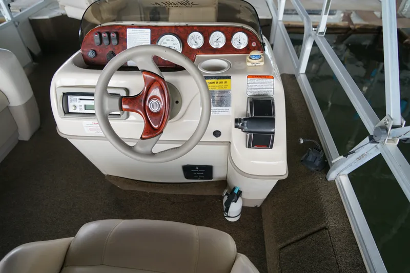 Slide: The Image of 2005 Sun Tracker Fishin' Barge 21 Signature Series dashboard with steering wheel and controls. - 13
