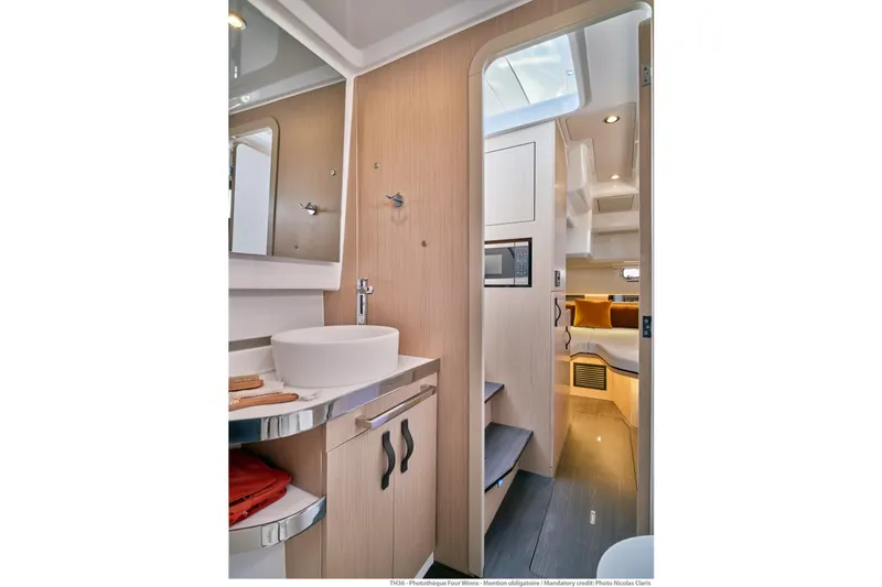 Slide: The Image of Modern interior of 2026 Jeanneau TH38 yacht featuring sleek bathroom and cozy cabin. - 3
