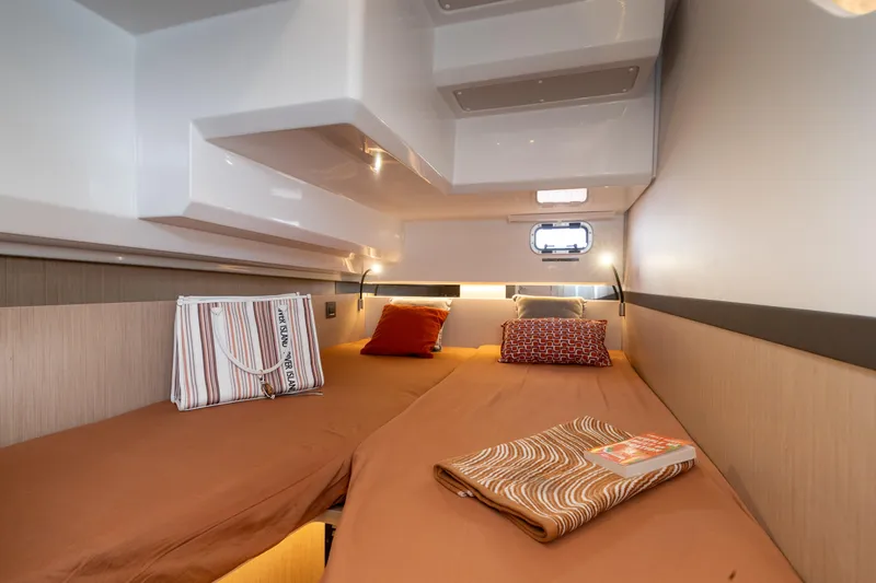 Slide: The Image of Cozy cabin interior of 2026 Jeanneau TH38 yacht with twin beds and stylish decor. - 8