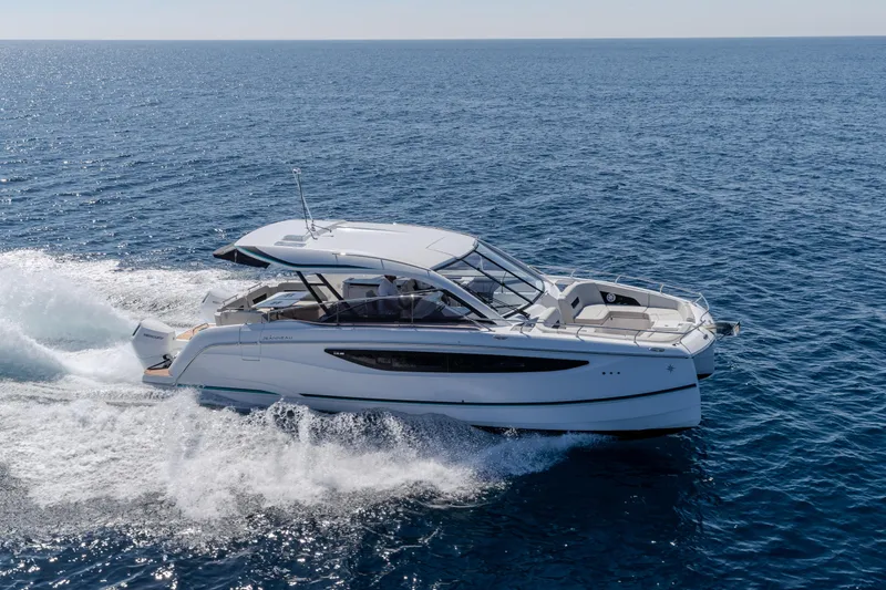 Slide: The Image of 2026 Jeanneau TH38 motor yacht cruising on open sea under clear skies. - 9