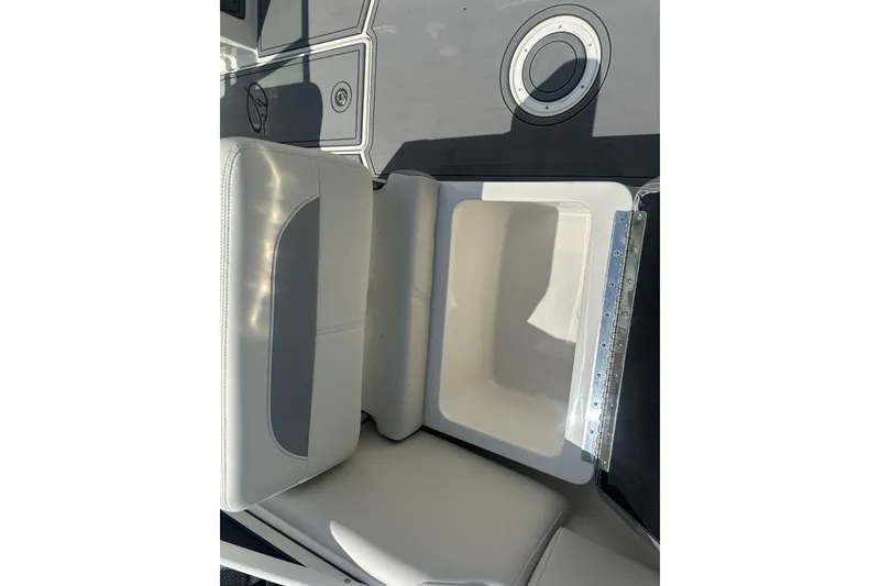 Slide: The Image of Interior view of 2026 Sailfish 236 DC boat, featuring a cushioned seat and storage compartment. - 25