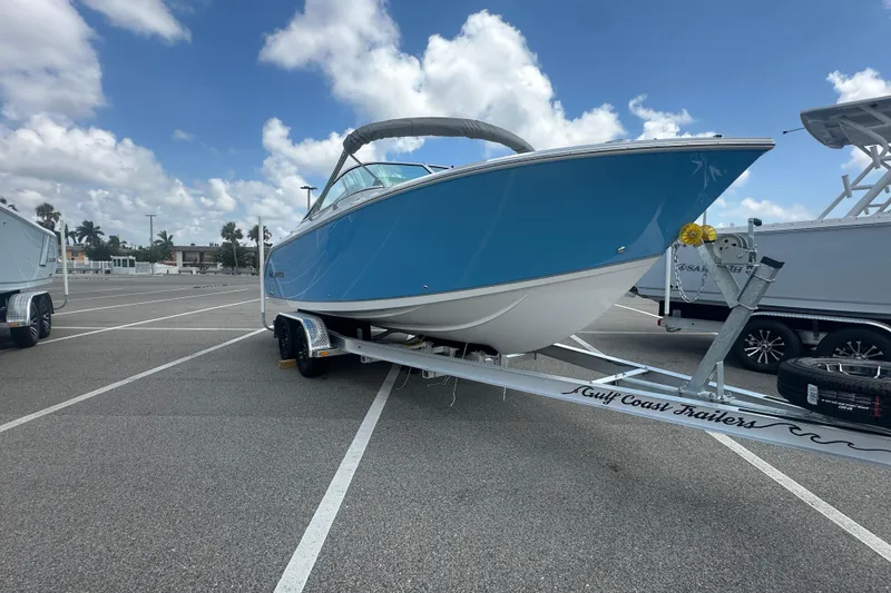 Slide: The Image of 2026 Sailfish 236 DC boat on trailer in parking lot under cloudy sky. - 13