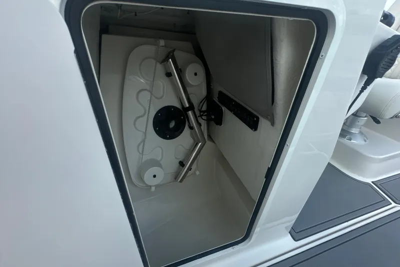 Slide: The Image of Storage compartment of 2026 Sailfish 236 DC boat, featuring interior equipment and seating. - 20