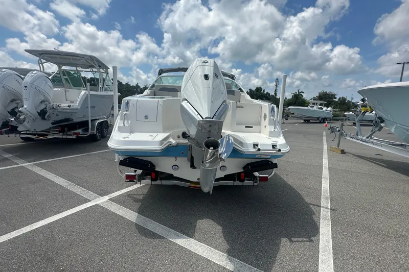 Slide: The Image of 2026 Sailfish 236 DC boat in parking lot, showcasing rear view and outboard motor. - 28