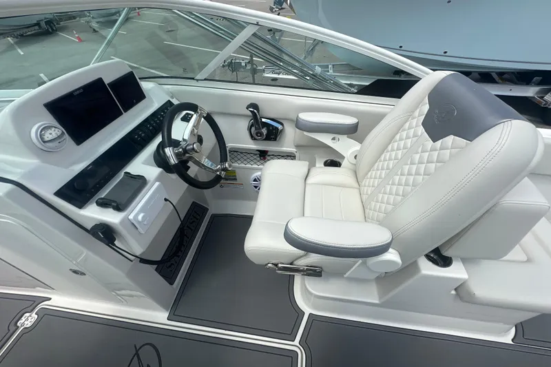 Slide: The Image of Helm of 2026 Sailfish 236 DC boat with modern controls and luxurious seating. - 31