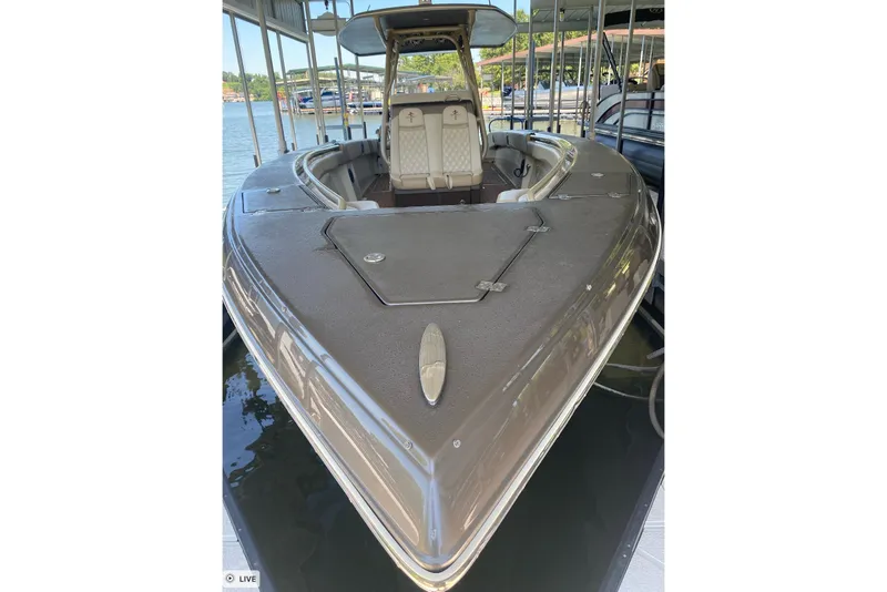 Slide: The Image of 2015 Statement 380 Open boat docked, showcasing sleek design and spacious seating. - 7
