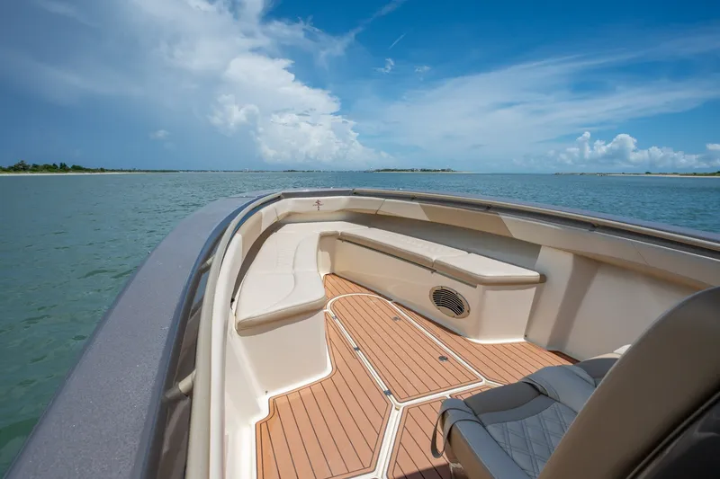 Slide: The Image of 2015 Statement 380 Open boat interior with seating, cruising on calm waters under a blue sky. - 28