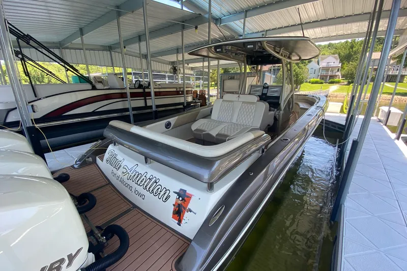 Slide: The Image of 2015 Statement 380 Open boat docked, featuring sleek design and comfortable seating. - 4