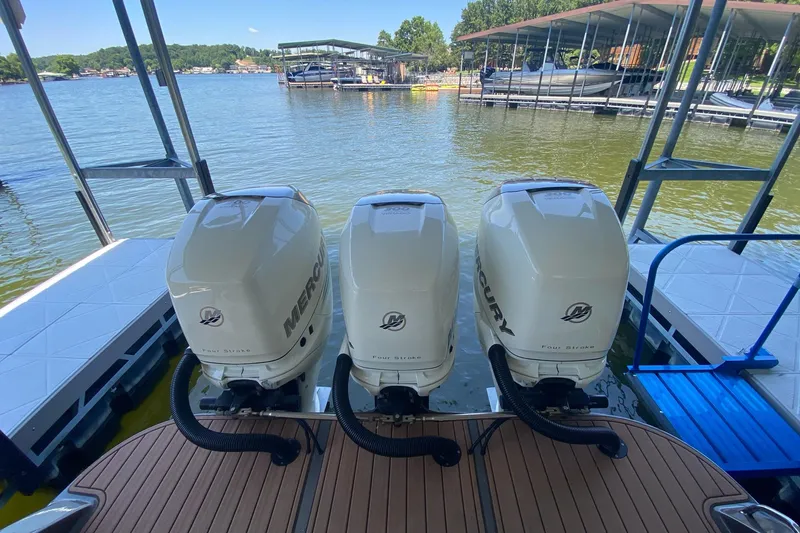 Slide: The Image of Triple Mercury outboard engines on a 2015 Statement 380 Open boat at a dock. - 5