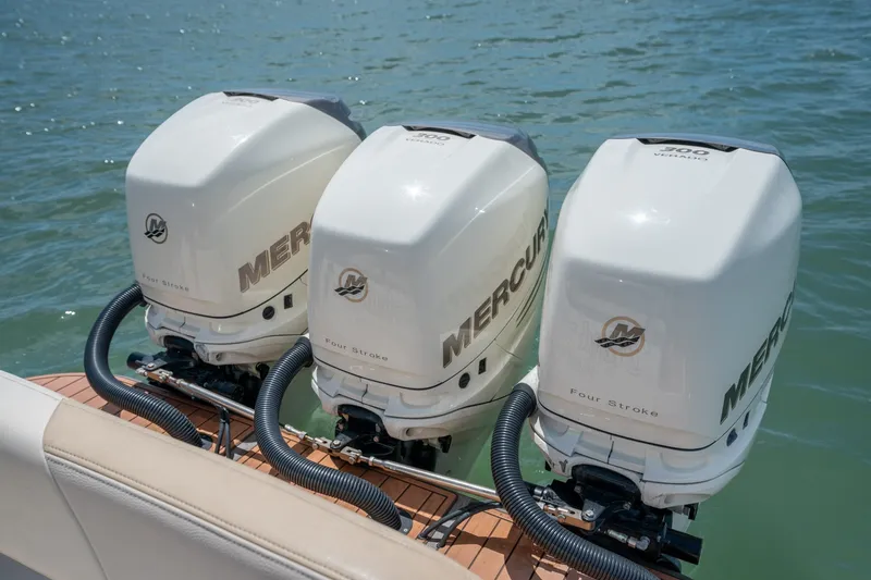 Slide: The Image of Triple Mercury outboard engines on a 2015 Statement 380 Open boat in water. - 7
