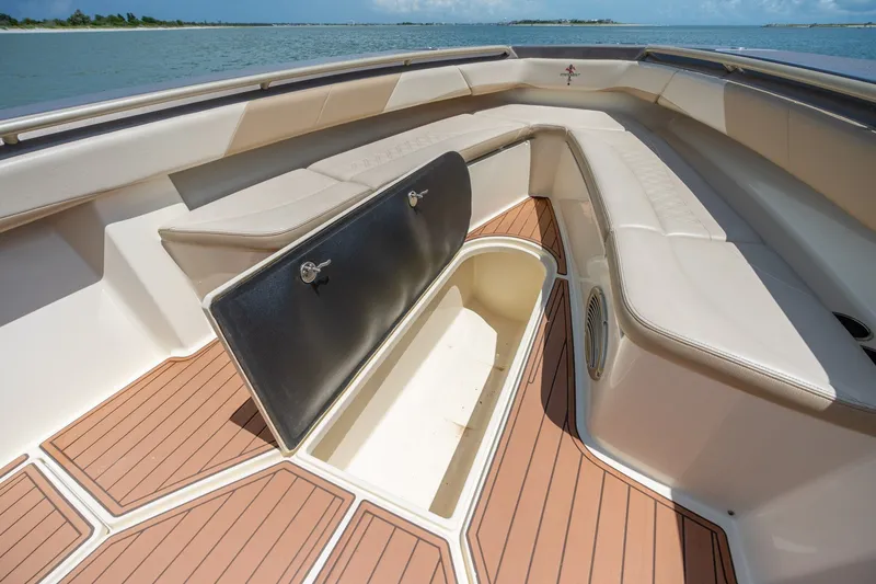 Slide: The Image of Spacious seating area on 2015 Statement 380 Open boat with storage compartment open. - 36
