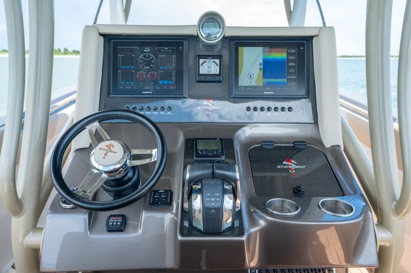 Slide: The Image of Control panel of a 2015 Statement 380 Open boat with navigation screens and steering wheel. - 26