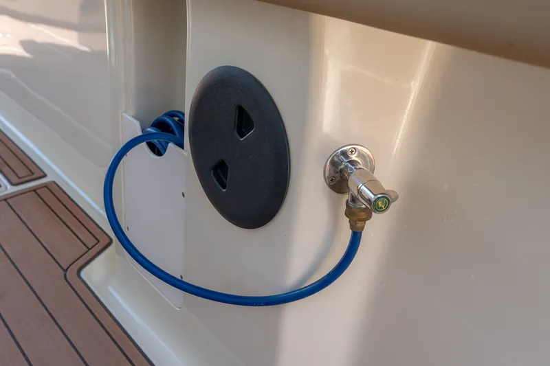 Slide: The Image of Boat deck with blue hose and water connection on 2015 Statement 380 Open. - 39