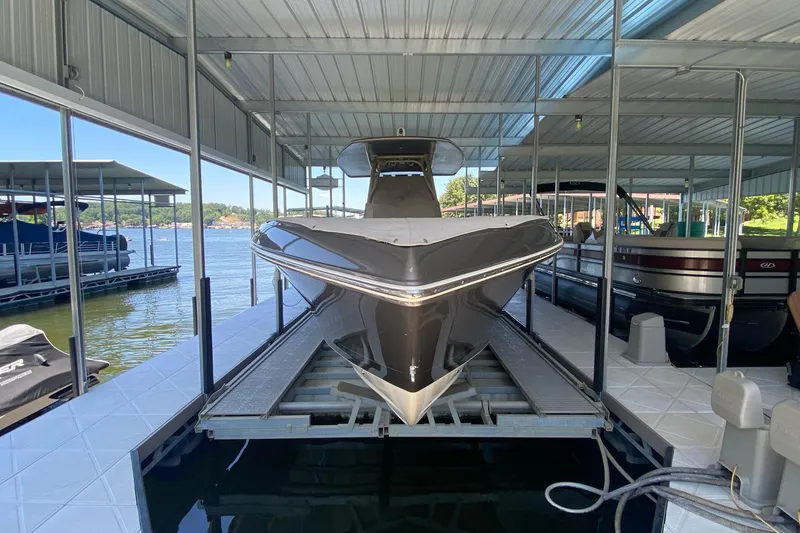 Slide: The Image of 2015 Statement 380 Open boat docked in a covered marina. - 8