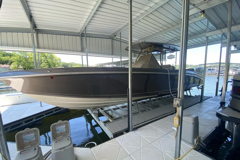 Slide: The Image of 2015 Statement 380 Open boat docked in covered marina slip. - 0