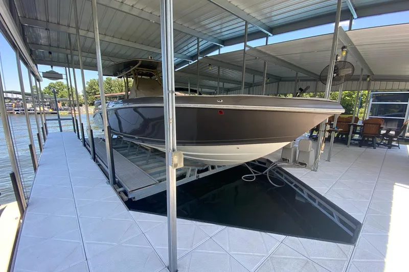 Slide: The Image of 2015 Statement 380 Open boat docked in covered marina slip. - 6