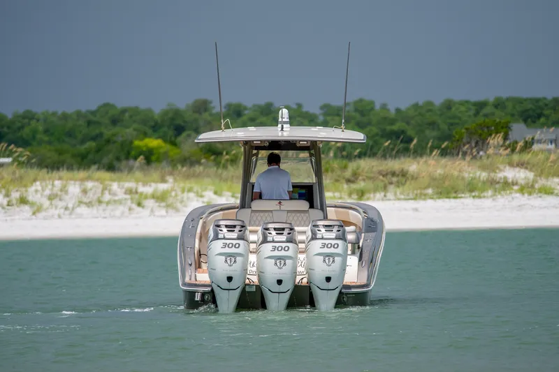 Slide: The Image of 2015 Statement 380 Open boat with triple 300 horsepower engines on water. - 21