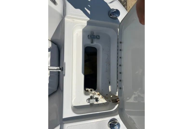 Slide: The Image of Open storage compartment on a 2002 Triton 2895 CC boat, showing interior details. - 6