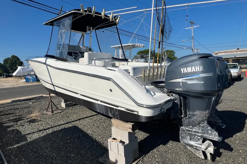 Slide: The Image of 2002 Triton 2895 CC boat with Yamaha outboard motor on display outdoors. - 4