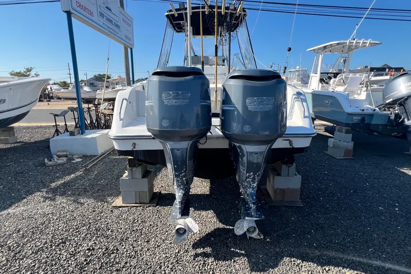 Slide: The Image of 2002 Triton 2895 CC boat with twin 225 horsepower engines on display. - 3