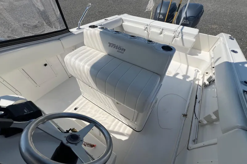 Slide: The Image of 2002 Triton 2895 CC boat interior with steering wheel and seating. - 16