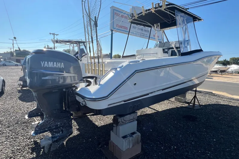 Slide: The Image of 2002 Triton 2895 CC boat with Yamaha outboard motor on display outdoors. - 2