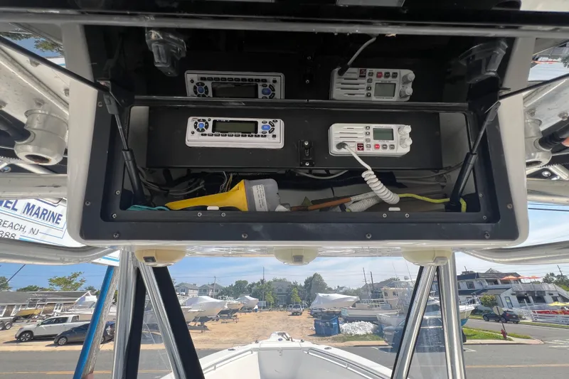 Slide: The Image of 2002 Triton 2895 CC boat dashboard with electronic controls and communication devices. - 23