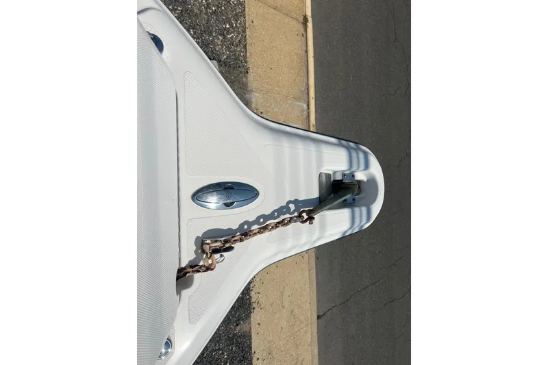 Slide: The Image of Bow of a 2002 Triton 2895 CC boat with anchor chain on pavement. - 7