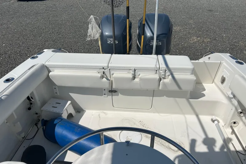 Slide: The Image of 2002 Triton 2895 CC boat interior with Yamaha 225 engines, white seating, and equipment. - 17