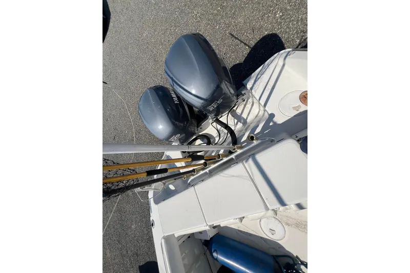 Slide: The Image of 2002 Triton 2895 CC boat with dual Yamaha outboard motors and fishing gear. - 24
