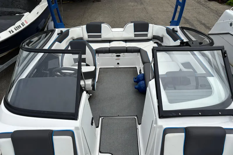 Slide: The Image of 2020 Yamaha Boats AR210 interior with seating and steering wheel, showcasing modern design. - 2