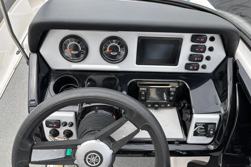 Slide: The Image of 2020 Yamaha AR210 boat dashboard with steering wheel, gauges, and control panel. - 5