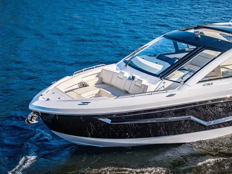 Slide: The Image of The 2027 Cruisers Yachts 42 GLS glides elegantly over blue water with a sleek, modern design. - 7