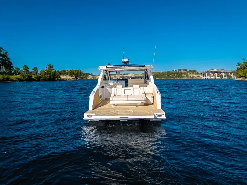 Slide: The Image of The 2027 Cruisers Yachts 42 GLS is cruising on calm waters under a clear blue sky. - 20