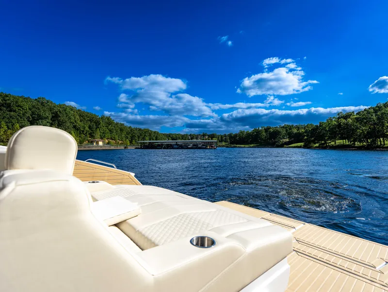 Slide: The Image of Luxurious sun deck of a yacht overlooking a serene lake and wooded shores. - 29