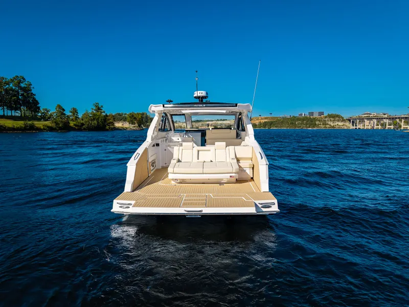 Slide: The Image of 2027 Cruisers Yachts 42 GLS on calm waters with a clear sky. - 17