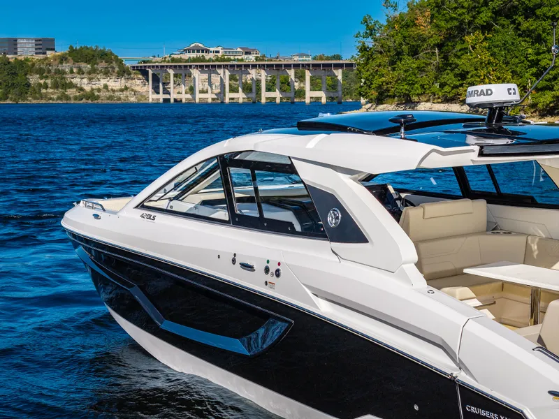 Slide: The Image of 2027 Cruisers Yachts 42 GLS on a lake with a bridge in the background. - 12