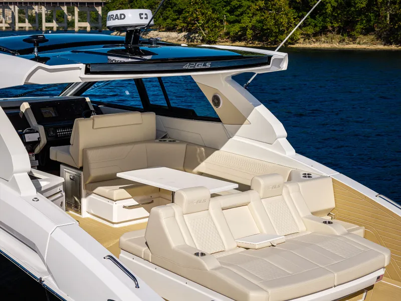 Slide: The Image of Luxurious 2027 Cruisers Yachts 42 GLS with sleek seating area and modern design on calm water. - 32
