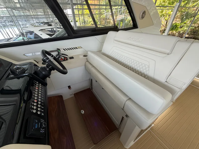 Slide: The Image of The image shows the cockpit of a 2027 Cruisers Yachts 42 GLS with modern controls and comfortable seating. - 29