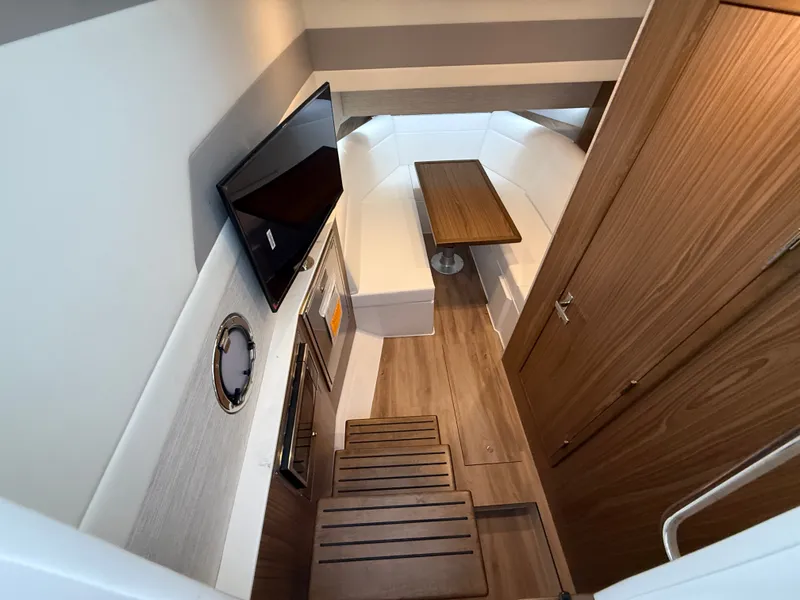 Slide: The Image of Interior of a modern yacht with wooden flooring, white sofa, and wall-mounted TV. - 44