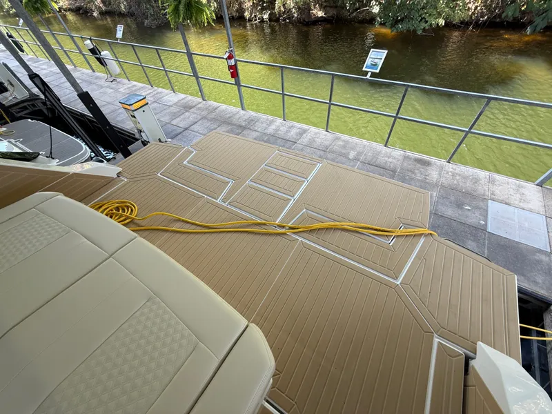 Slide: The Image of The image shows the deck of a 2027 Cruisers Yachts 42 GLS, with a yellow cable on it. - 8